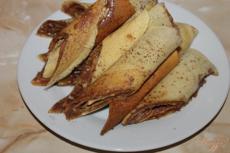 Фото приготовление рецепта: Сладкие блины на кислом молоке с ореховой пастой и орехами шаг №8